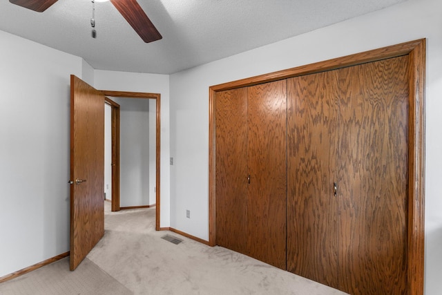 9755 Egret Blvd NW, Coon Rapids, MN 55433 - unfurnished bedroom featuring light carpet, a closet, ceiling fan, and a textured ceiling
