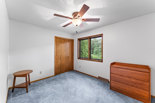 9755 Egret Blvd NW, Coon Rapids, MN 55433 - unfurnished bedroom featuring carpet flooring, a closet, ceiling fan, and a textured ceiling