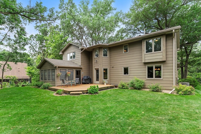 9755 Egret Blvd NW, Coon Rapids, MN 55433 - rear view of house featuring a deck, a yard, and a sunroom