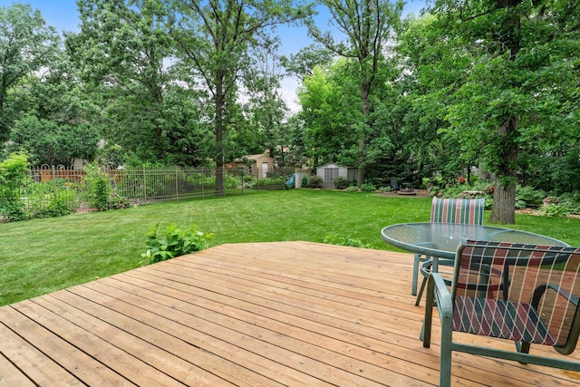 9755 Egret Blvd NW, Coon Rapids, MN 55433 - deck featuring a shed, outdoor dining space, a fenced backyard, and view of scattered trees