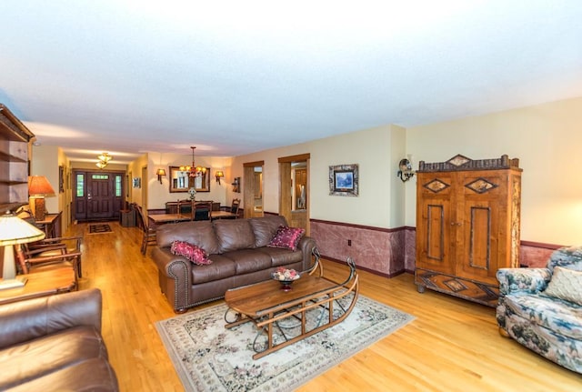 22855 Lake Hubert Dr, Lake Edward Twp, MN 56401 - living room featuring a chandelier, wood finished floors, and a wainscoted wall