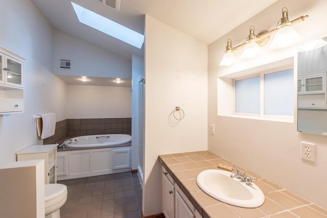22855 Lake Hubert Dr, Lake Edward Twp, MN 56401 - full bath featuring a skylight, vaulted ceiling, a bath, vanity, and toilet