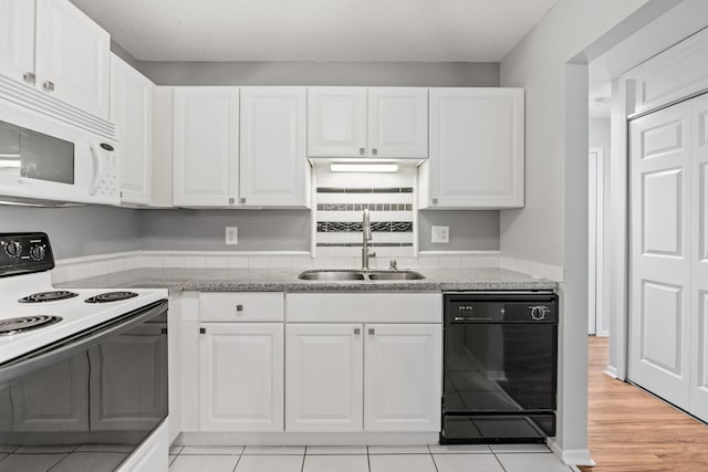 3425 Golfview Dr Unit 308, Eagan, MN 55123 - kitchen featuring black dishwasher, electric stove, white microwave, a sink, and white cabinets