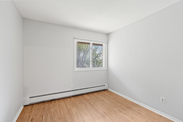 3425 Golfview Dr Unit 308, Eagan, MN 55123 - empty room with a baseboard heating unit, wood finished floors, and baseboards