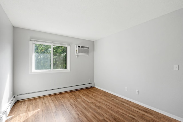 3425 Golfview Dr Unit 308, Eagan, MN 55123 - unfurnished room with a baseboard radiator, baseboard heating, an AC wall unit, wood finished floors, and baseboards