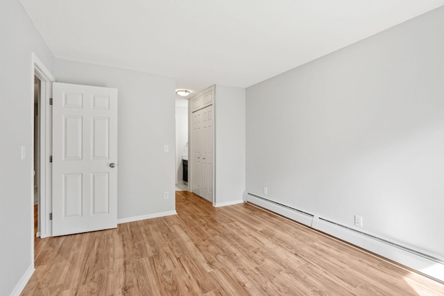 3425 Golfview Dr Unit 308, Eagan, MN 55123 - unfurnished bedroom with a baseboard radiator, light wood-style flooring, baseboards, and a closet