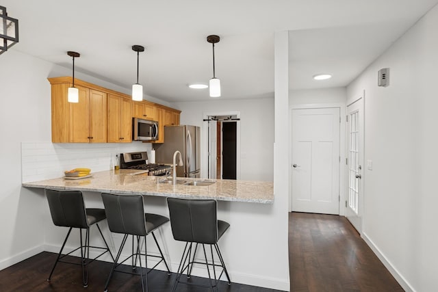 14933 Echo Way, Apple Valley, MN 55124 - kitchen with appliances with stainless steel finishes, baseboards, a peninsula, a sink, and dark wood finished floors