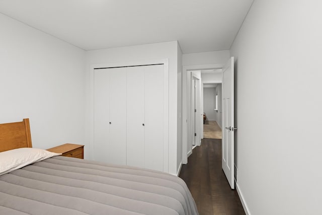 14933 Echo Way, Apple Valley, MN 55124 - bedroom featuring a closet, dark wood-style floors, and baseboards