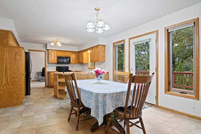 12351 Holly St NW, Coon Rapids, MN 55448 - dining area featuring a chandelier, light floors, a textured ceiling, and baseboards