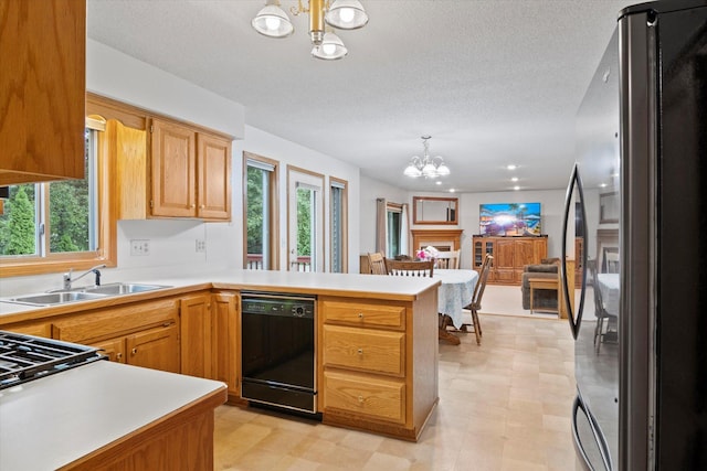 12351 Holly St NW, Coon Rapids, MN 55448 - kitchen with freestanding refrigerator, a chandelier, dishwasher, a sink, and plenty of natural light