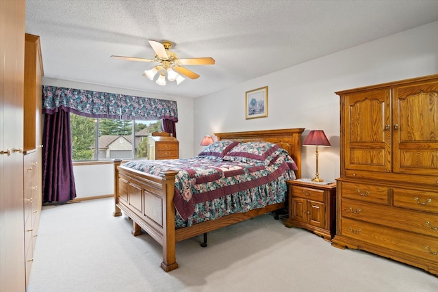 12351 Holly St NW, Coon Rapids, MN 55448 - bedroom featuring light carpet, ceiling fan, and a textured ceiling