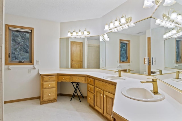 12351 Holly St NW, Coon Rapids, MN 55448 - full bath with double vanity, a textured ceiling, and baseboards