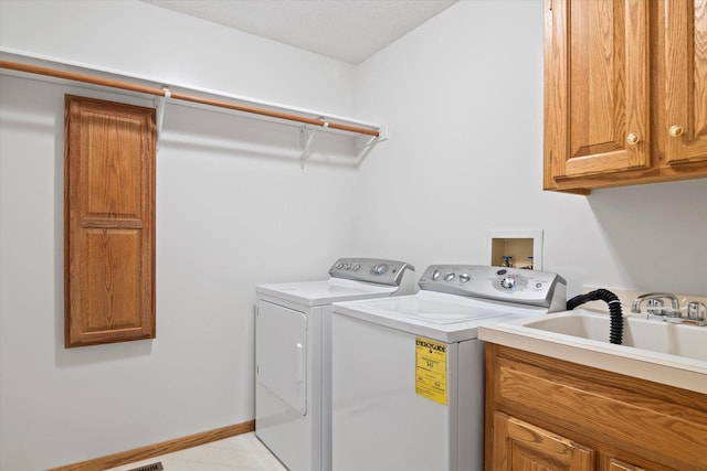 12351 Holly St NW, Coon Rapids, MN 55448 - laundry room featuring washer and clothes dryer, cabinet space, and baseboards