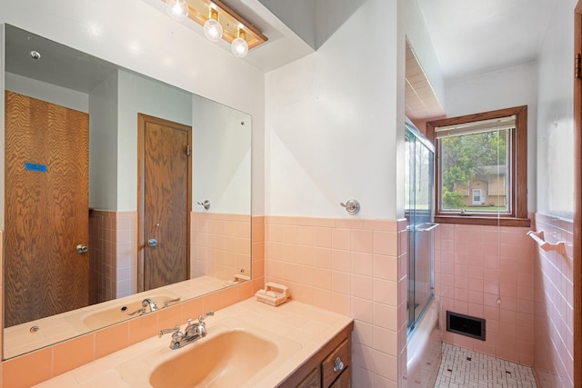 3801 Vandan Rd, Minnetonka, MN 55345 - full bathroom with tile walls, vanity, a wainscoted wall, combined bath / shower with glass door, and tile patterned flooring