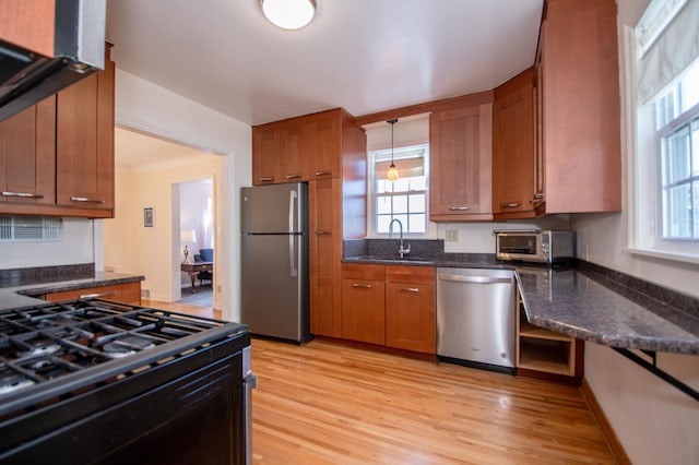 1904 Saunders Ave, Saint Paul, MN 55116 - kitchen with appliances with stainless steel finishes, a sink, brown cabinets, and light wood-style flooring