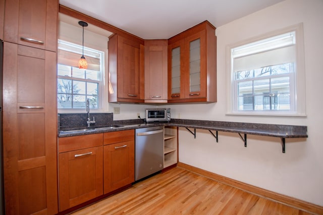 1904 Saunders Ave, Saint Paul, MN 55116 - kitchen featuring stainless steel dishwasher, a sink, light wood finished floors, brown cabinets, and plenty of natural light