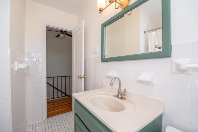 1904 Saunders Ave, Saint Paul, MN 55116 - bathroom with tile walls, tile patterned floors, vanity, wainscoting, and a ceiling fan