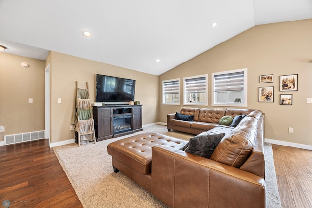 5409 47th Ave S, Fargo, ND 58104 - living area featuring lofted ceiling, wood finished floors, recessed lighting, baseboards, and a glass covered fireplace