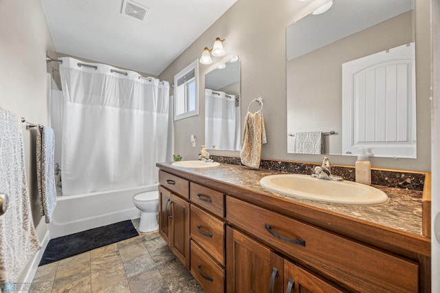 5409 47th Ave S, Fargo, ND 58104 - full bath featuring double vanity, shower / bath combo with shower curtain, toilet, and stone finish flooring