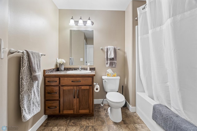 5409 47th Ave S, Fargo, ND 58104 - full bathroom with vanity, toilet, baseboards, shower / bath combo, and stone finish flooring