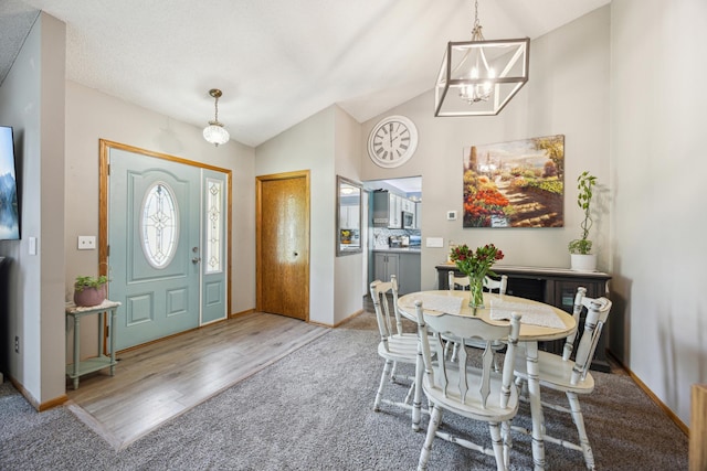1435 104th Ln NW, Coon Rapids, MN 55433 - foyer entrance featuring a chandelier, wood finished floors, baseboards, vaulted ceiling, and carpet