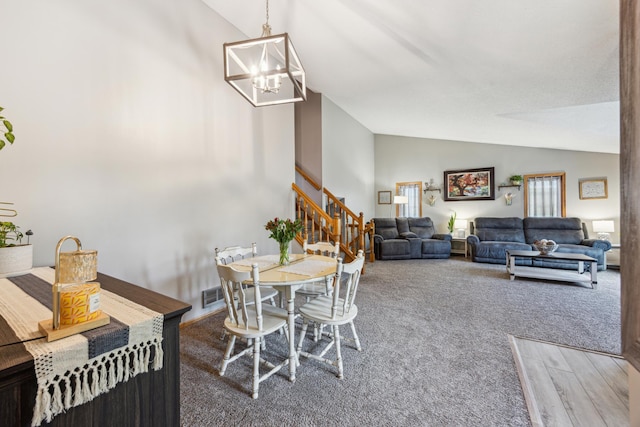 1435 104th Ln NW, Coon Rapids, MN 55433 - carpeted dining area with lofted ceiling, stairway, and a chandelier