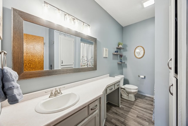 1435 104th Ln NW, Coon Rapids, MN 55433 - bathroom with wood finished floors, vanity, toilet, and baseboards