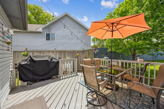 1435 104th Ln NW, Coon Rapids, MN 55433 - deck featuring outdoor dining area, a fenced backyard, and a grill