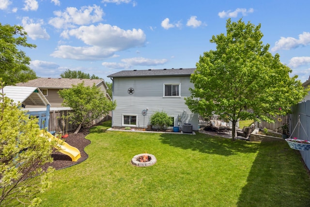 1435 104th Ln NW, Coon Rapids, MN 55433 - rear view of house with central AC unit, a playground, and an outdoor fire pit