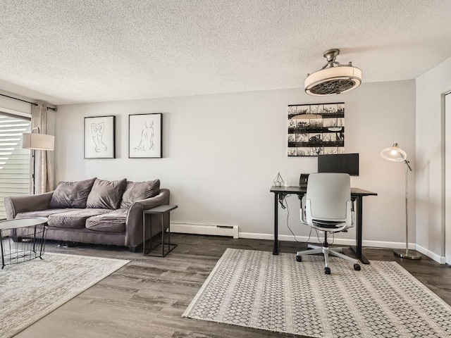 7354 72nd Ln N Unit 324, Brooklyn Park, MN 55428 - office area featuring baseboard heating, wood finished floors, a textured ceiling, and baseboards