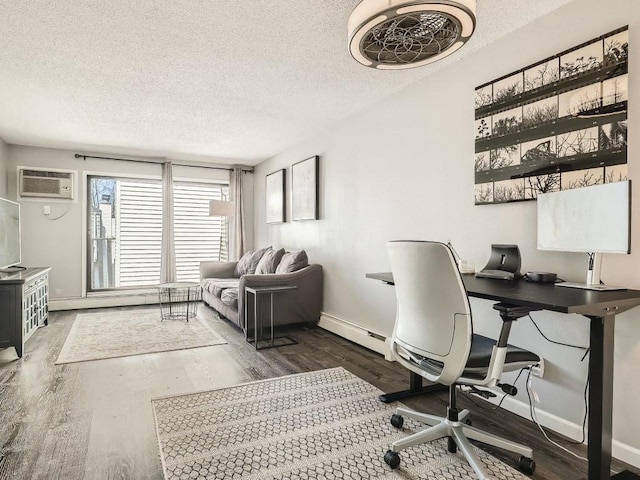 7354 72nd Ln N Unit 324, Brooklyn Park, MN 55428 - office area featuring wood finished floors, a textured ceiling, baseboards, an AC wall unit, and baseboard heating