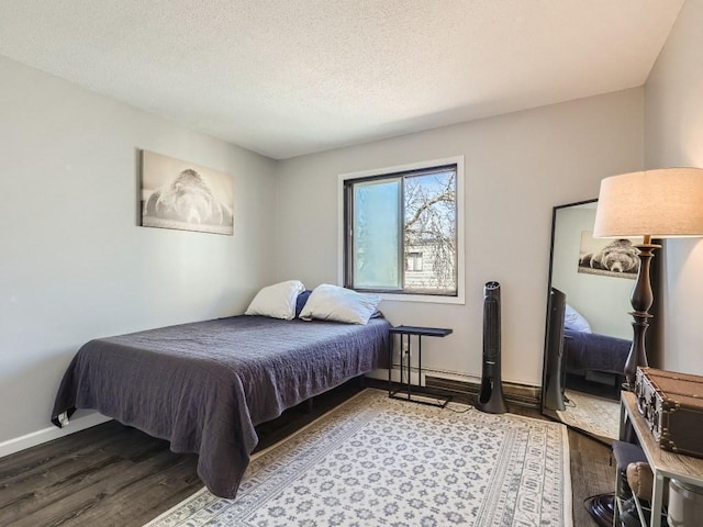 7354 72nd Ln N Unit 324, Brooklyn Park, MN 55428 - bedroom featuring wood finished floors, baseboards, and a textured ceiling