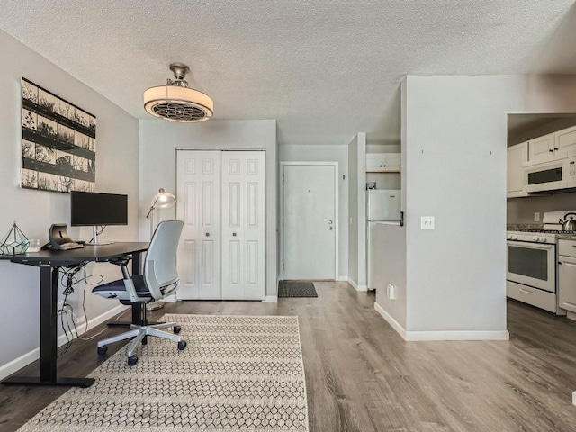 7354 72nd Ln N Unit 324, Brooklyn Park, MN 55428 - office space with wood finished floors, baseboards, and a textured ceiling