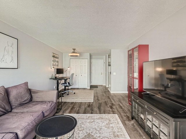 7354 72nd Ln N Unit 324, Brooklyn Park, MN 55428 - living room featuring wood finished floors, a desk, a textured ceiling, and baseboards