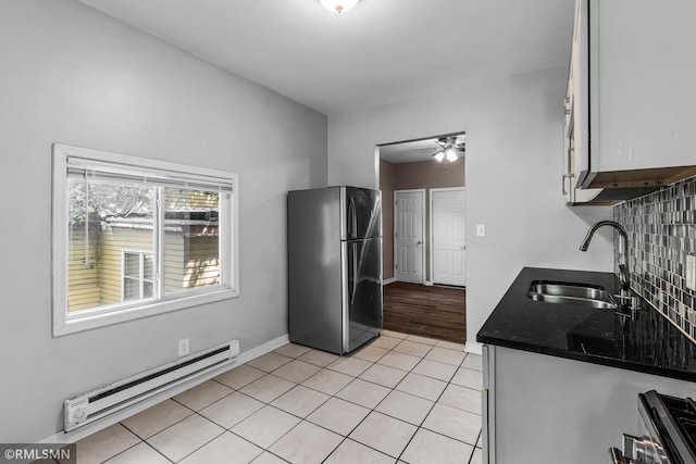 485 Belvidere St E, Saint Paul, MN 55107 - kitchen with freestanding refrigerator, baseboard heating, a sink, dark countertops, and ceiling fan