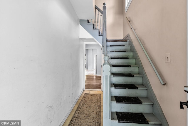 485 Belvidere St E, Saint Paul, MN 55107 - staircase featuring tile patterned flooring, a high ceiling, and baseboards