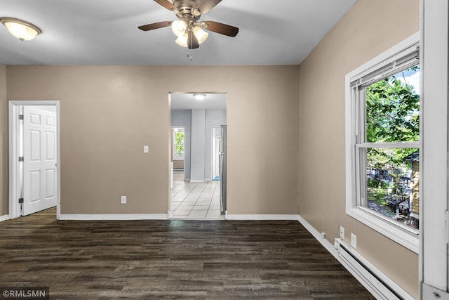 485 Belvidere St E, Saint Paul, MN 55107 - spare room with a baseboard radiator, ceiling fan, baseboards, and wood finished floors