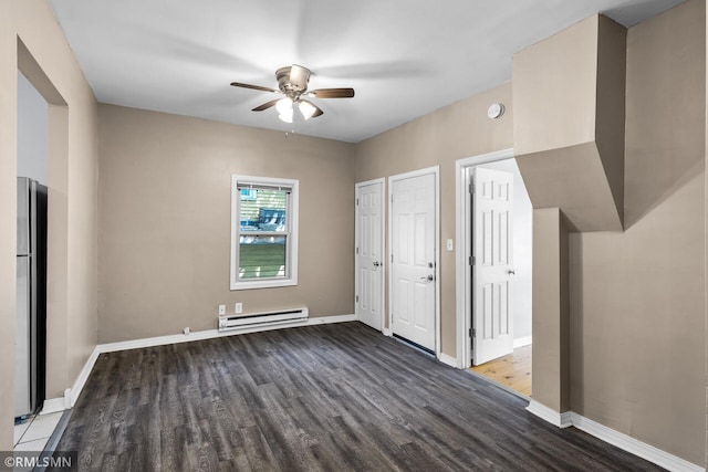 485 Belvidere St E, Saint Paul, MN 55107 - unfurnished bedroom with baseboard heating, wood finished floors, freestanding refrigerator, and baseboards
