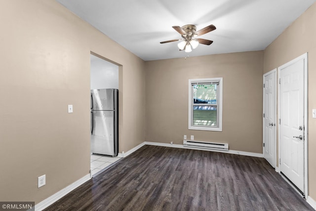485 Belvidere St E, Saint Paul, MN 55107 - unfurnished room featuring a baseboard heating unit, wood finished floors, ceiling fan, and baseboards