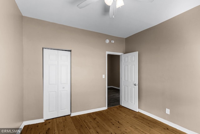 485 Belvidere St E, Saint Paul, MN 55107 - unfurnished bedroom featuring baseboards, wood finished floors, a closet, and a ceiling fan