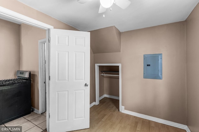 485 Belvidere St E, Saint Paul, MN 55107 - unfurnished bedroom featuring electric panel, washer / dryer, baseboards, a closet, and light wood finished floors