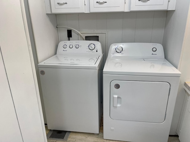 33008 Birch Ln, Motley, MN 56466 - laundry area with independent washer and dryer, cabinet space, and light wood-type flooring
