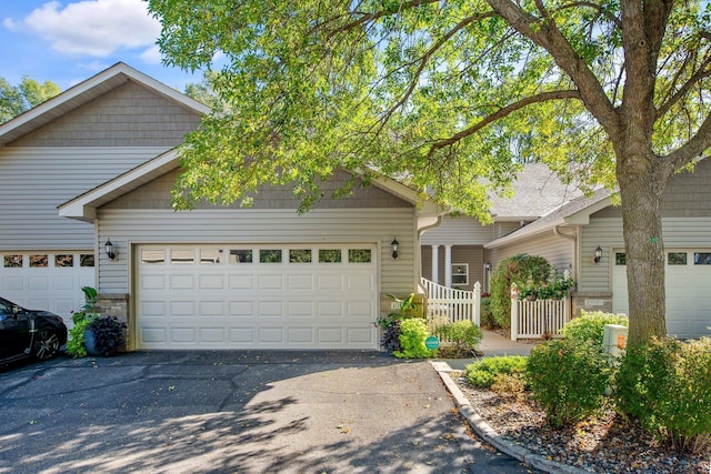 10014 Cove Dr, Hopkins, MN 55305 - view of front of house with asphalt driveway and a garage