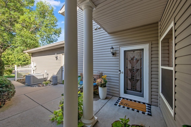 10014 Cove Dr, Hopkins, MN 55305 - doorway to property with cooling unit and a patio area