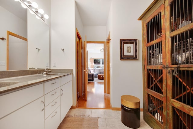 10014 Cove Dr, Hopkins, MN 55305 - full bath featuring double vanity, tile patterned flooring, and ensuite bath