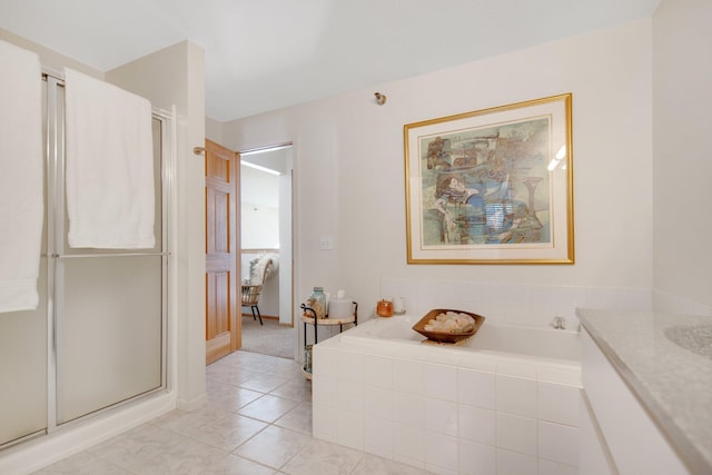 10014 Cove Dr, Hopkins, MN 55305 - bathroom with a stall shower, a garden tub, tile patterned floors, and baseboards