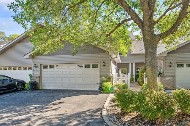 10014 Cove Dr, Hopkins, MN 55305 - view of front of house featuring driveway and an attached garage