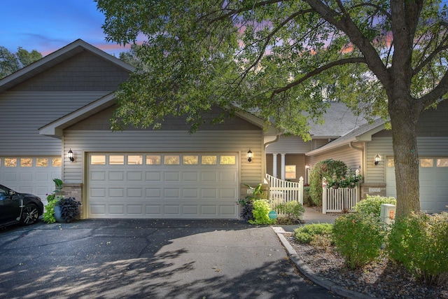 10014 Cove Dr, Hopkins, MN 55305 - view of front of home with asphalt driveway and an attached garage