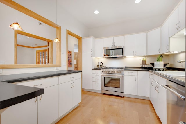 10014 Cove Dr, Hopkins, MN 55305 - kitchen featuring appliances with stainless steel finishes, a sink, dark countertops, light wood-type flooring, and recessed lighting