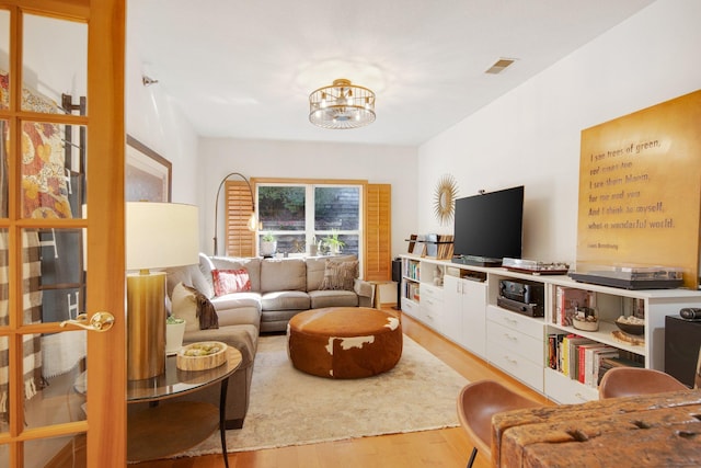 10014 Cove Dr, Hopkins, MN 55305 - living area with wood finished floors and a chandelier